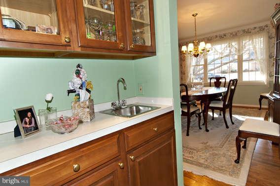 3721 Ligon Road Ellicott City, MD 21042 - Photo 21 of 30 a kitchen with a sink a table and chairs in it