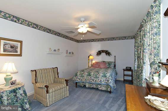3721 Ligon Road Ellicott City, MD 21042 - Photo 24 of 30 a bedroom with furniture and a chandelier