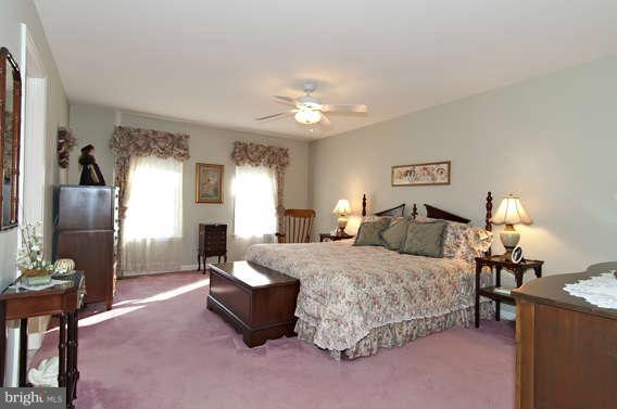 3721 Ligon Road Ellicott City, MD 21042 - Photo 6 of 30 a spacious bedroom with a bed and a chandelier