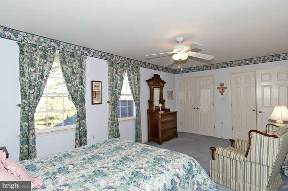 3721 Ligon Road Ellicott City, MD 21042 - Photo 8 of 30 a bedroom with a bed and a chandelier
