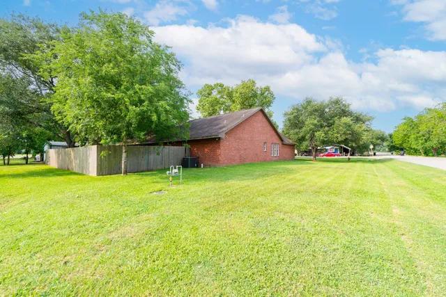 a view of a house with a yard and sitting area