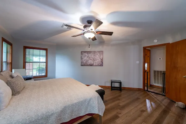 a bedroom with a bed and a chandelier