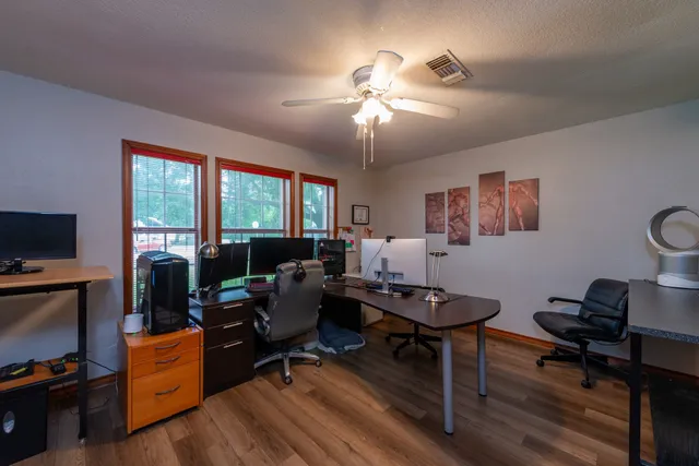 a living room with furniture a flat screen tv and a window