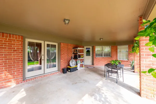 a view of a house with backyard porch and sitting area