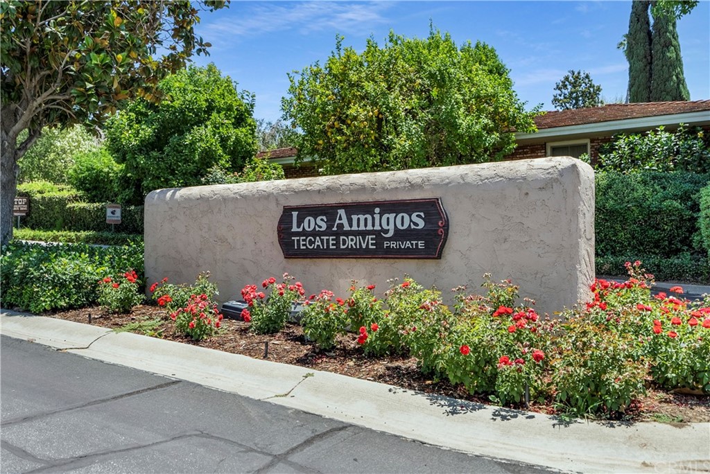 a view of sign board with flower plants