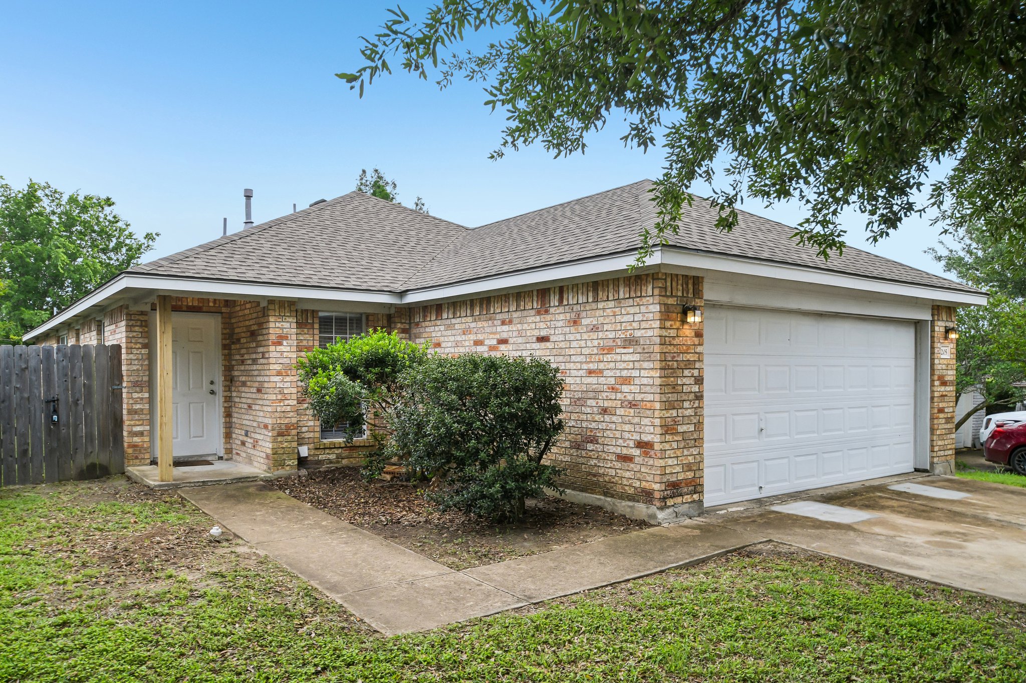205 Cavalry Trail Elgin, TX 78621 - Photo 1 of 32 a view of a house with yard and plants