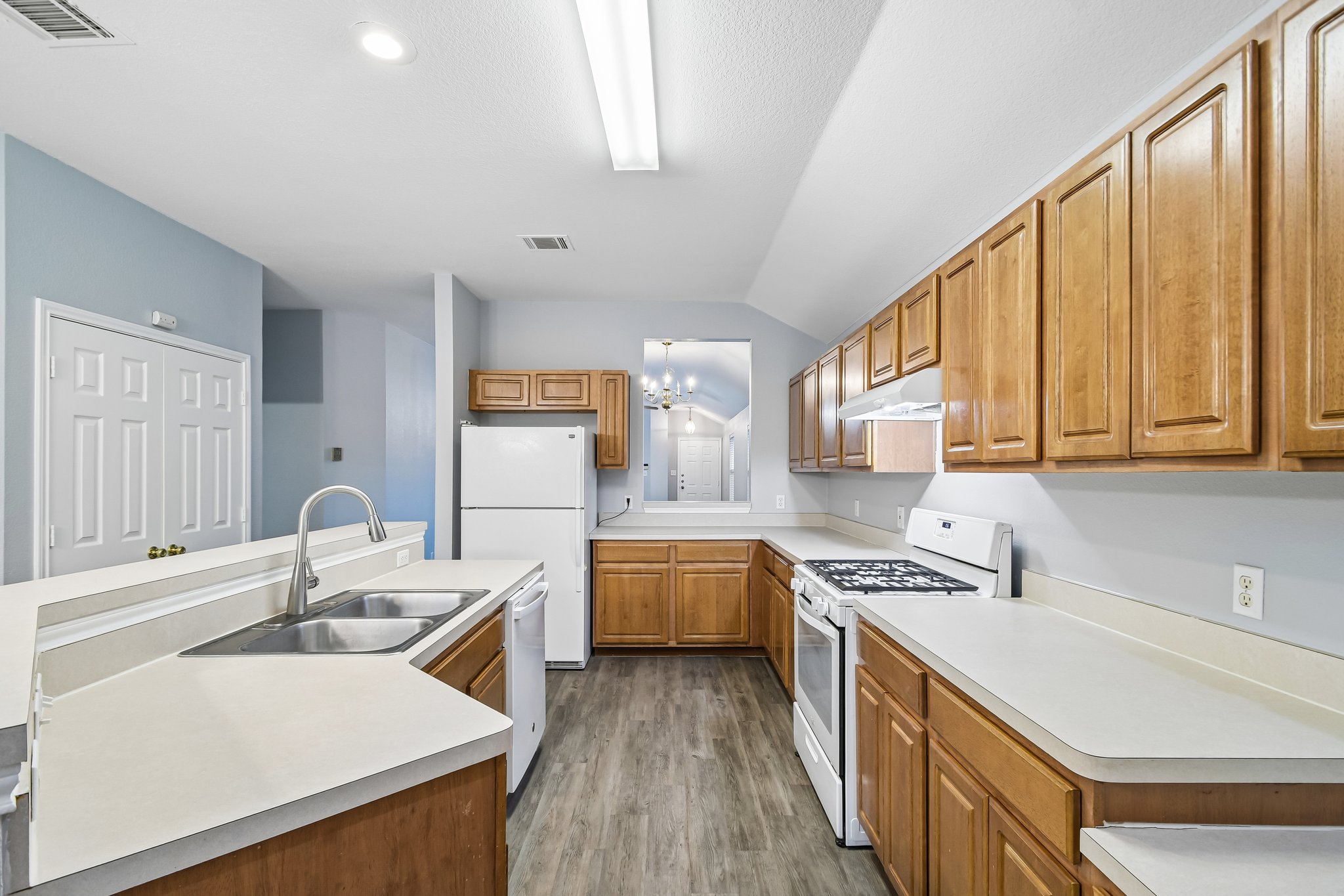 205 Cavalry Trail Elgin, TX 78621 - Photo 14 of 32 a kitchen with a sink stove and cabinets