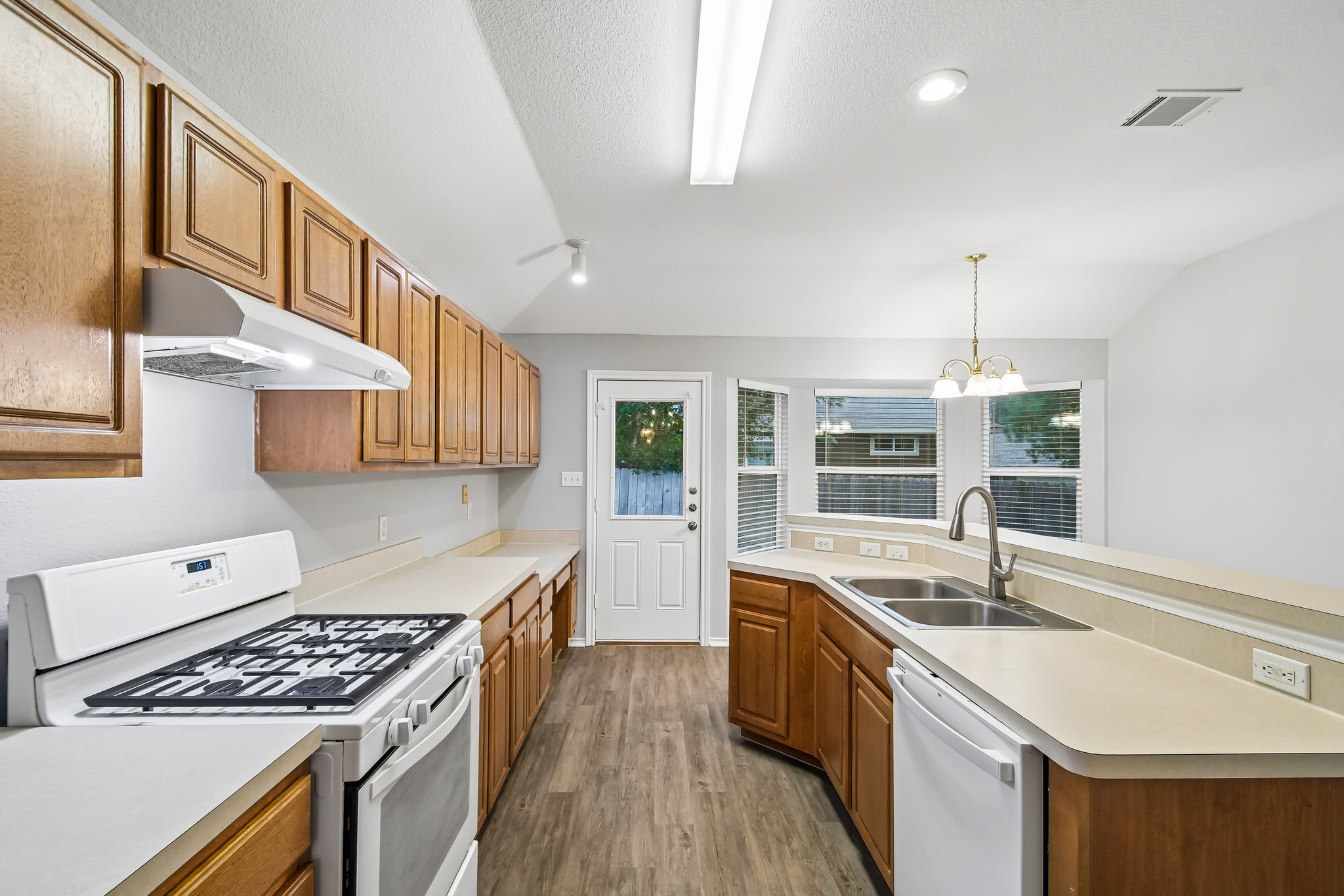 205 Cavalry Trail Elgin, TX 78621 - Photo 15 of 32 a kitchen with a sink stove and cabinets
