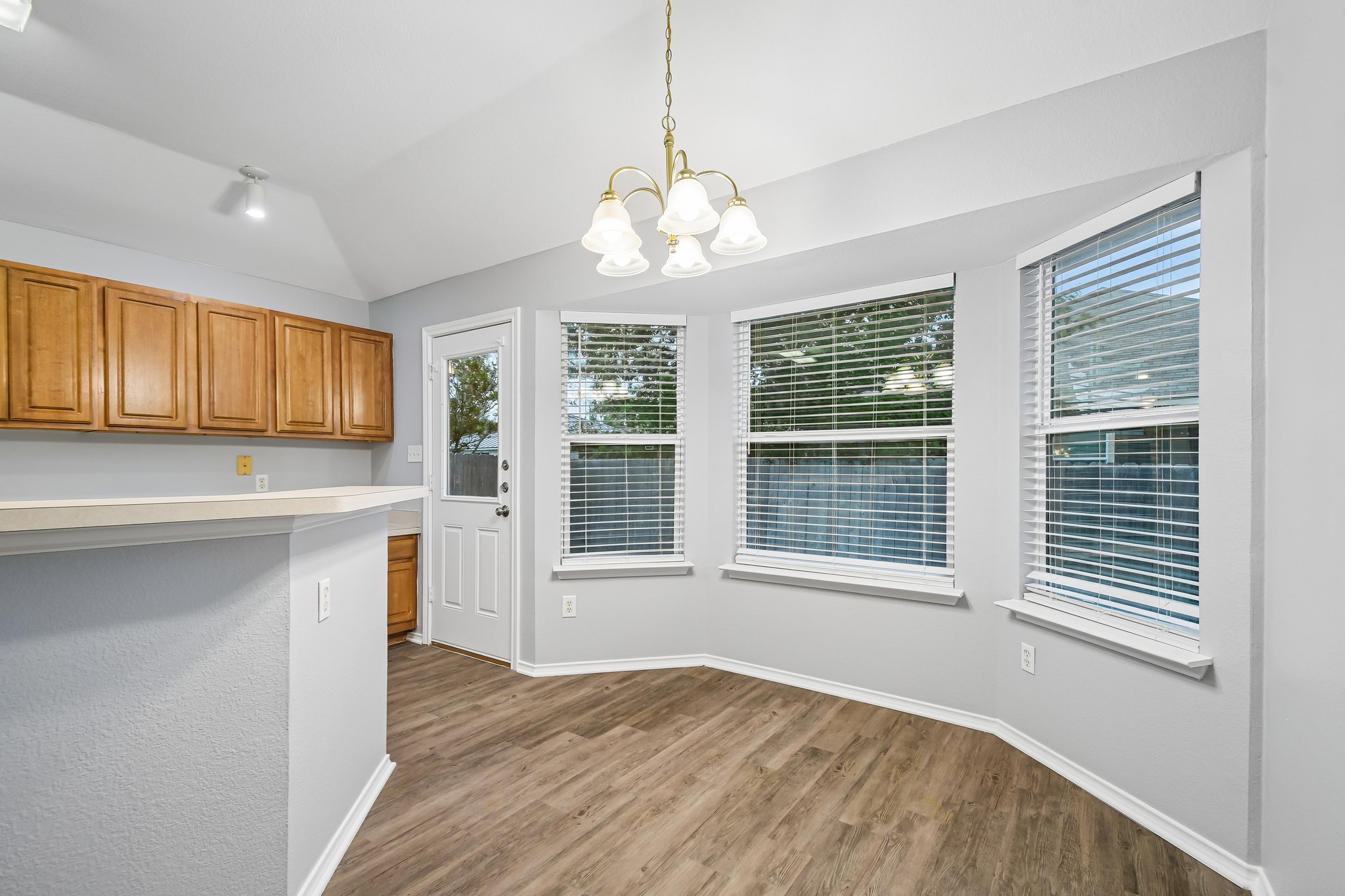 205 Cavalry Trail Elgin, TX 78621 - Photo 16 of 32 a view of an empty room with a window and wooden floor