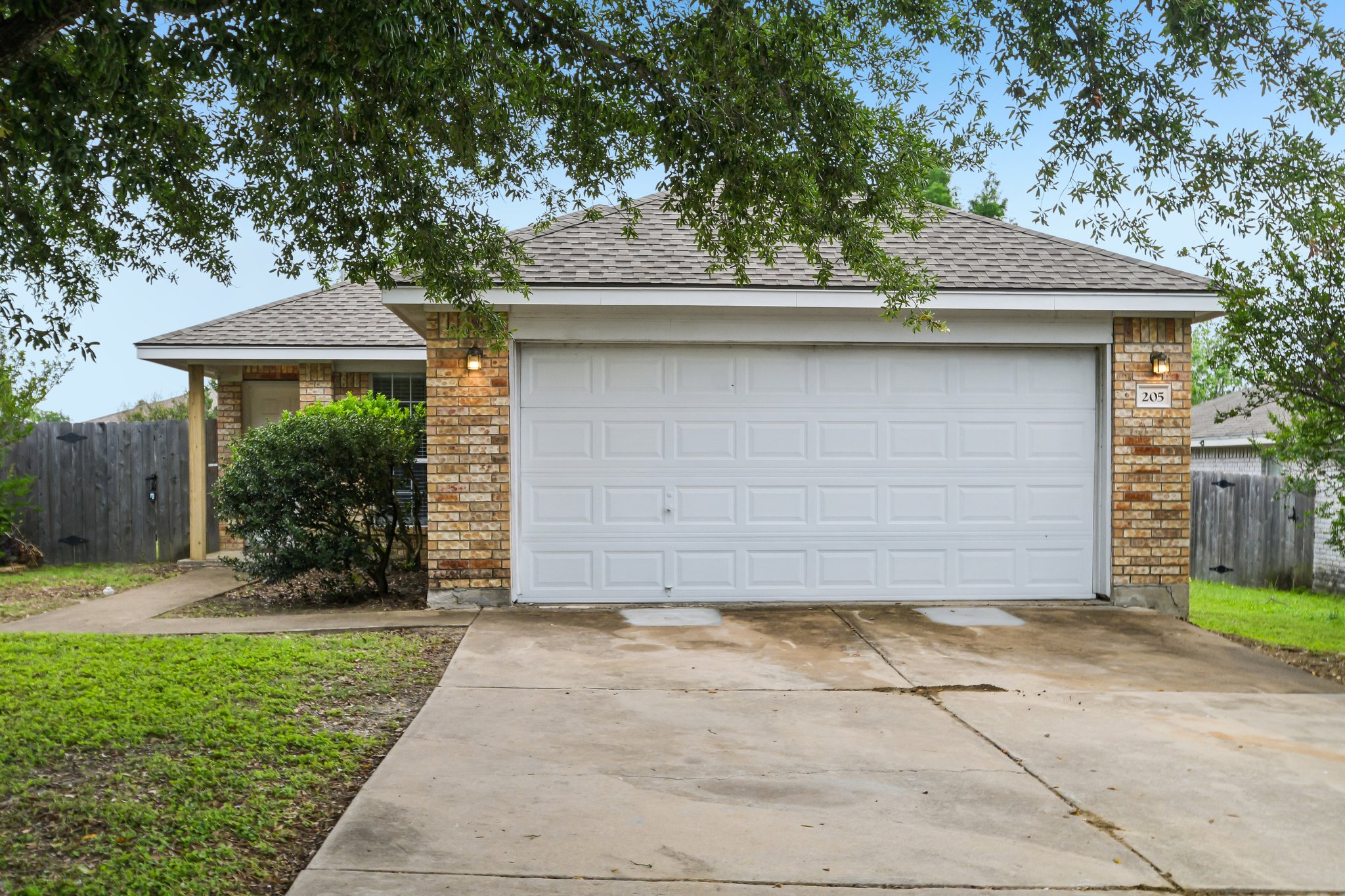 205 Cavalry Trail Elgin, TX 78621 - Photo 2 of 32 a front view of a house with garden