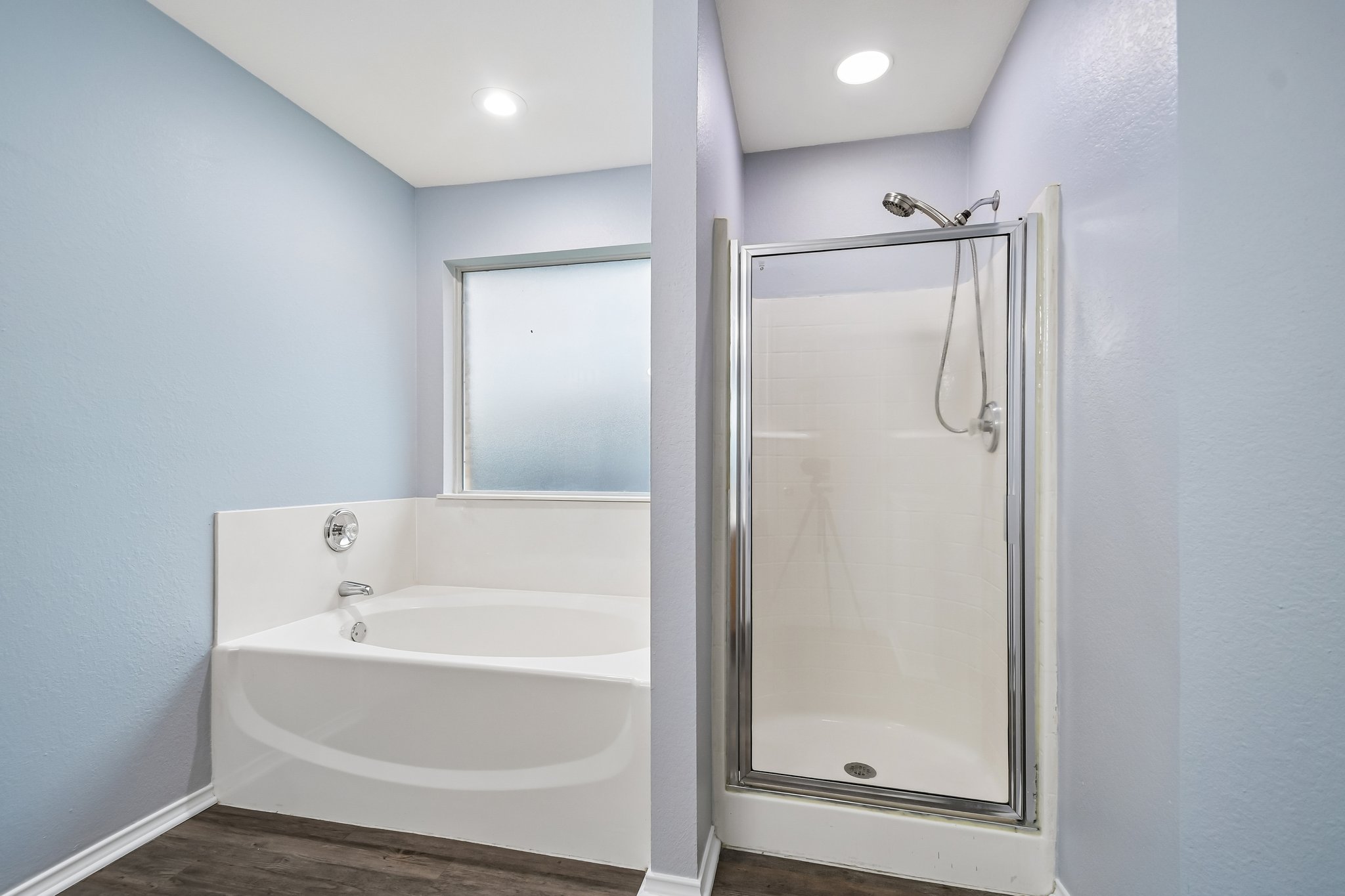 205 Cavalry Trail Elgin, TX 78621 - Photo 22 of 32 a bathroom with a bathtub and a shower