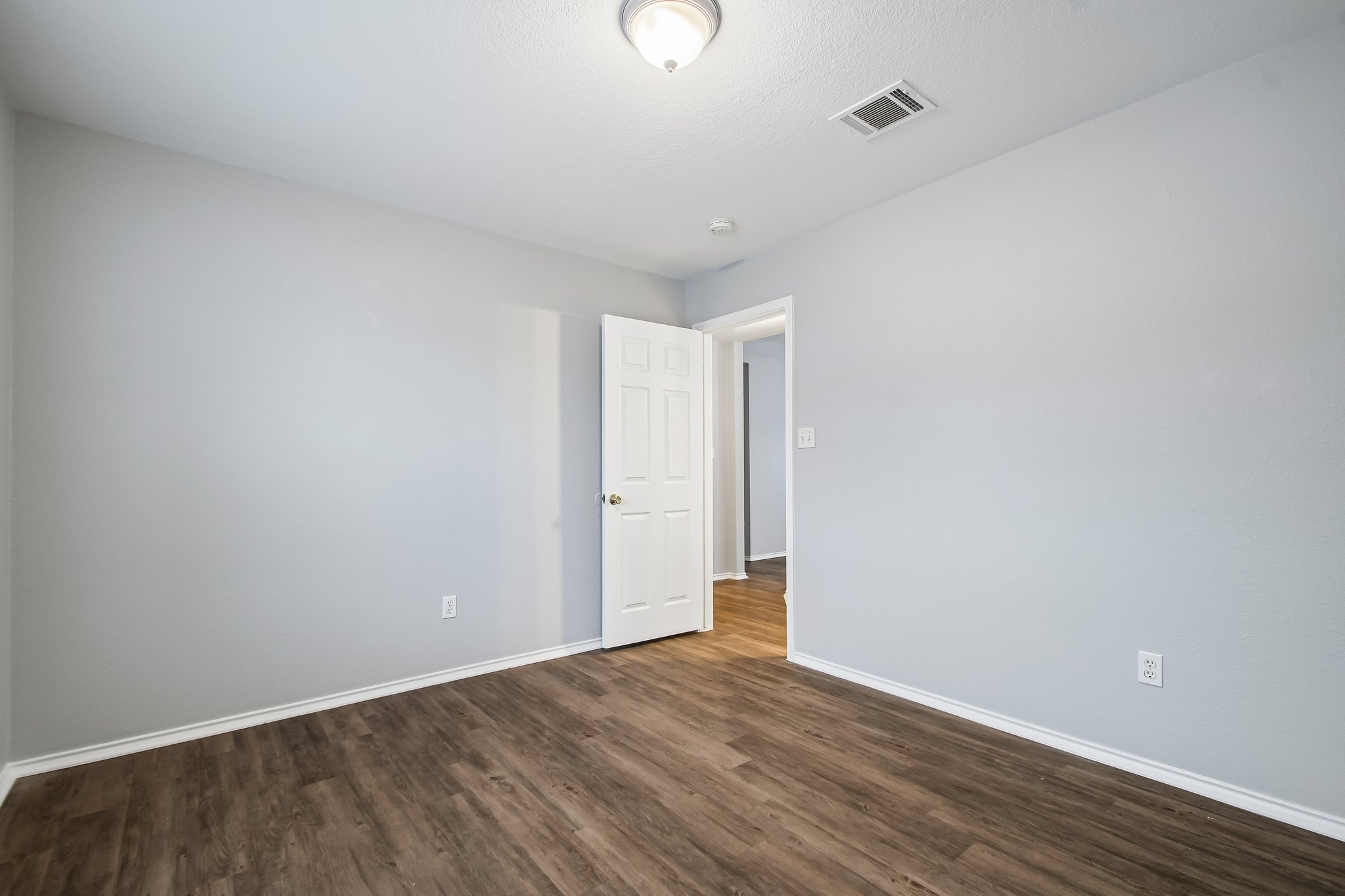 205 Cavalry Trail Elgin, TX 78621 - Photo 26 of 32 a view of an empty room with wooden floor