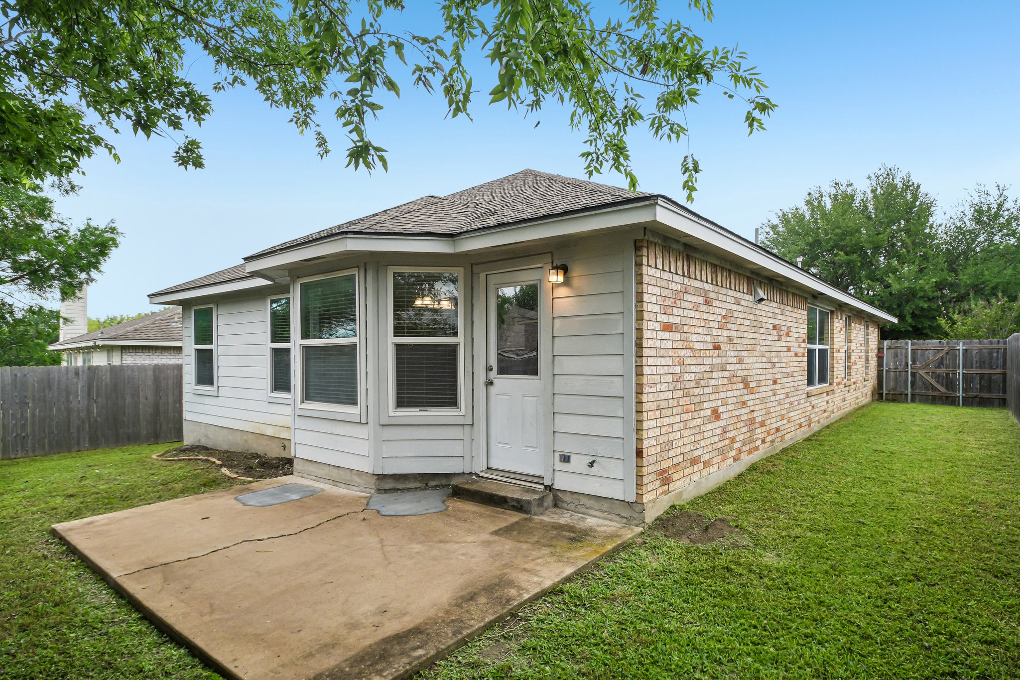 205 Cavalry Trail Elgin, TX 78621 - Photo 30 of 32 a front view of a house with garden