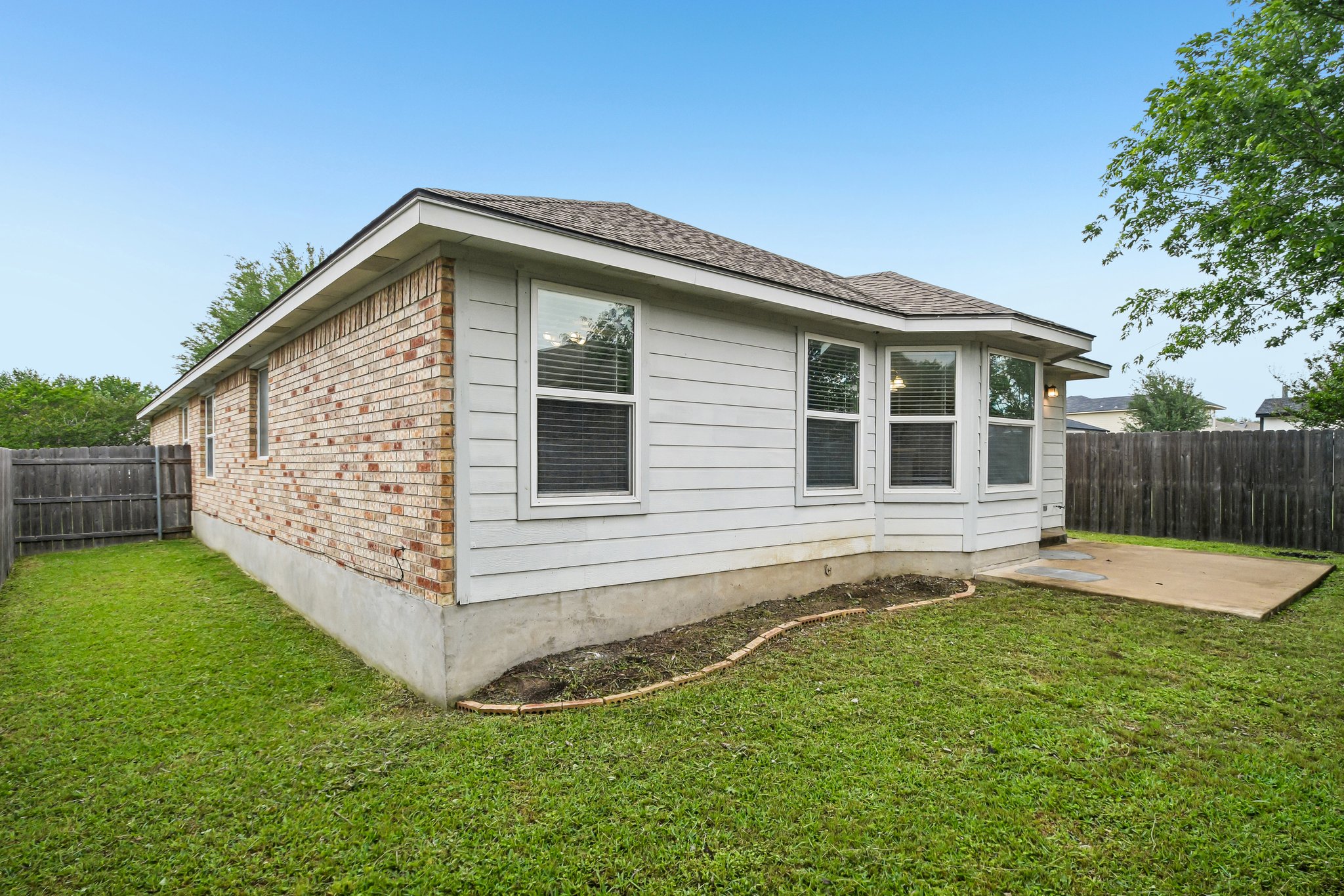 205 Cavalry Trail Elgin, TX 78621 - Photo 31 of 32 a backyard of a house with lots of green space