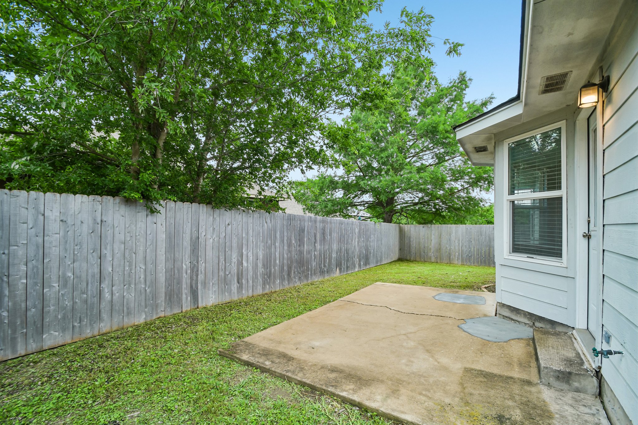 205 Cavalry Trail Elgin, TX 78621 - Photo 32 of 32 a view of a backyard with wooden fence