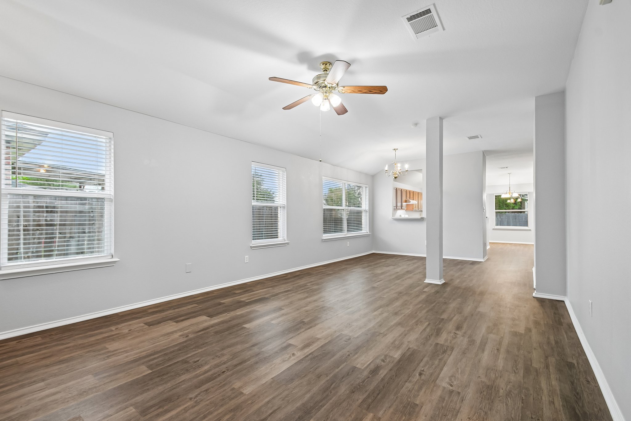 205 Cavalry Trail Elgin, TX 78621 - Photo 6 of 32 a view of an empty room with wooden floor and a window
