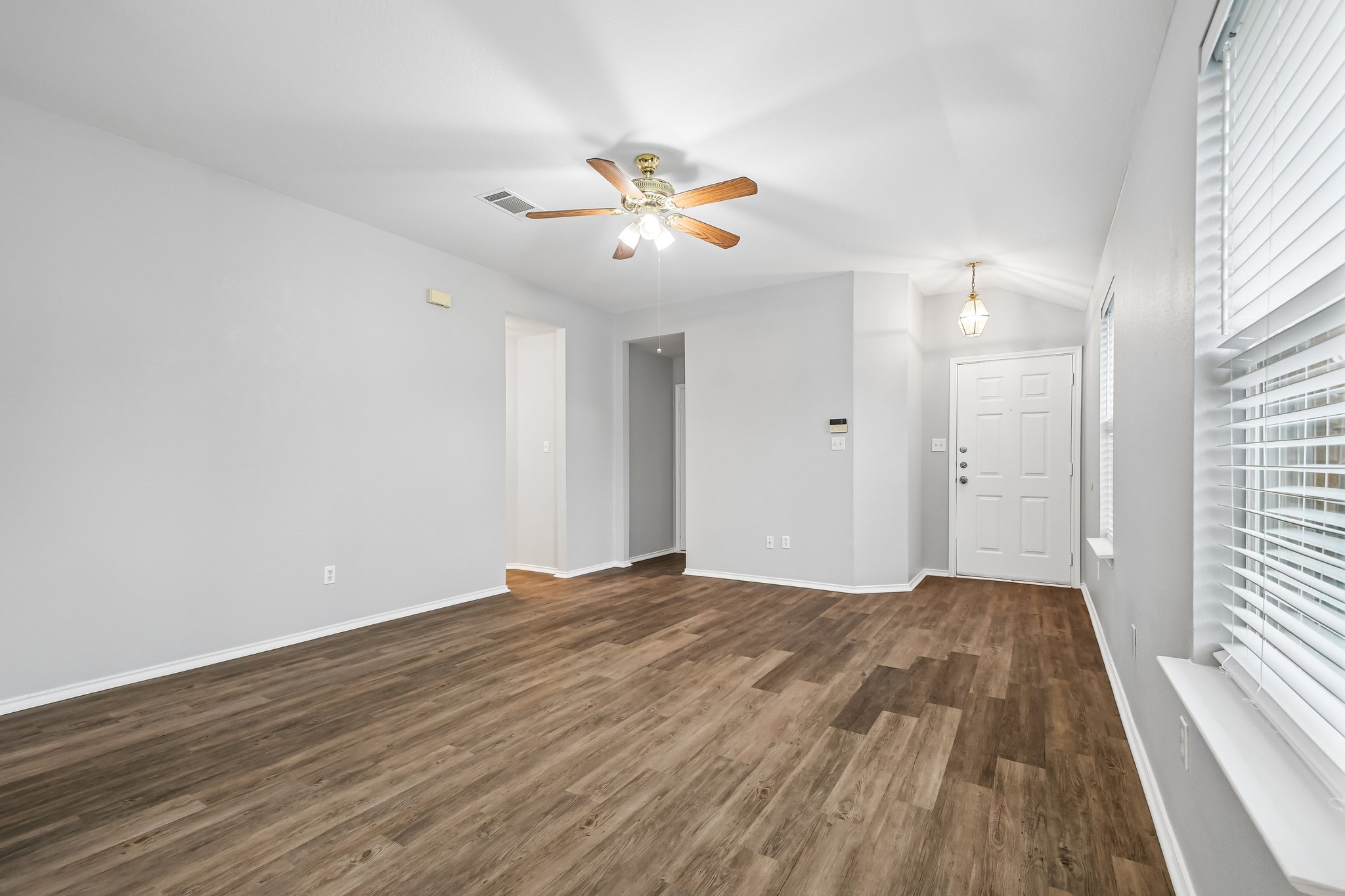 205 Cavalry Trail Elgin, TX 78621 - Photo 8 of 32 wooden floor in an empty room with a window