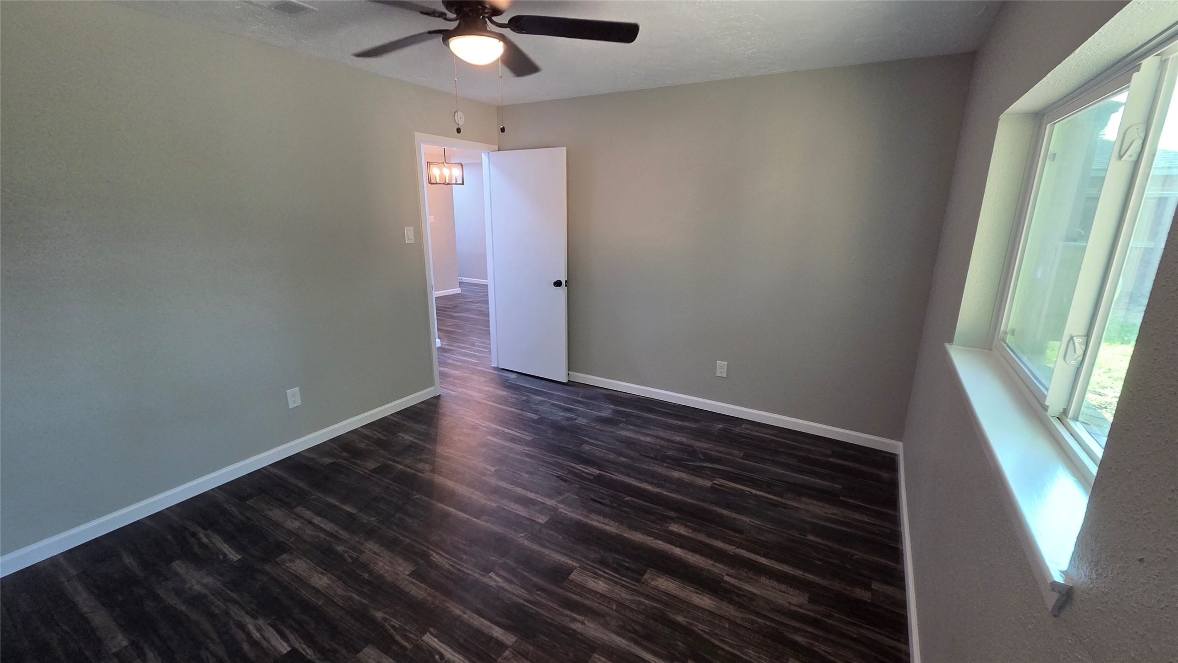 4815 Hickorygate Drive Spring, TX 77373 - Photo 12 of 16 a view of an empty room with wooden floor and a window