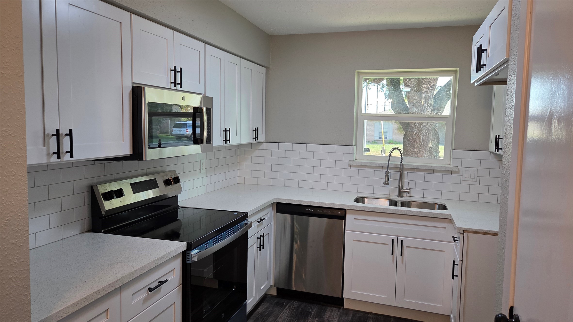 4815 Hickorygate Drive Spring, TX 77373 - Photo 4 of 16 a kitchen with a sink stove and microwave