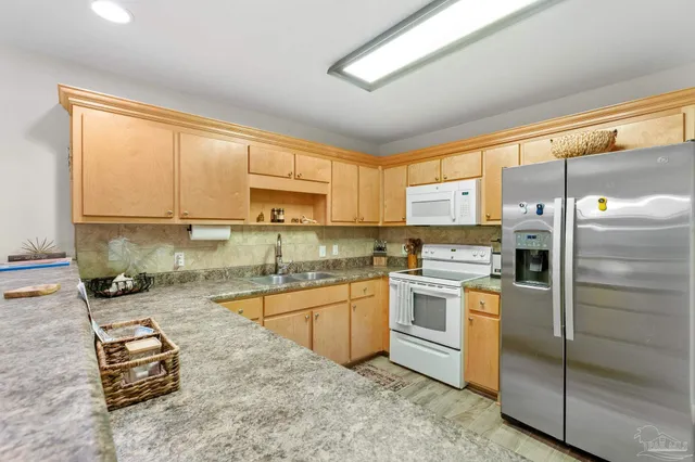 a kitchen with a window a sink and a refrigerator