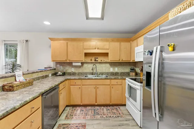 a kitchen with a sink stove and refrigerator