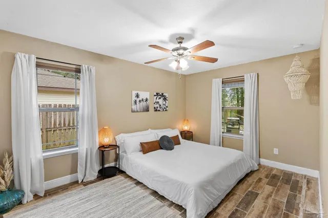 a bedroom with a large bed and a window