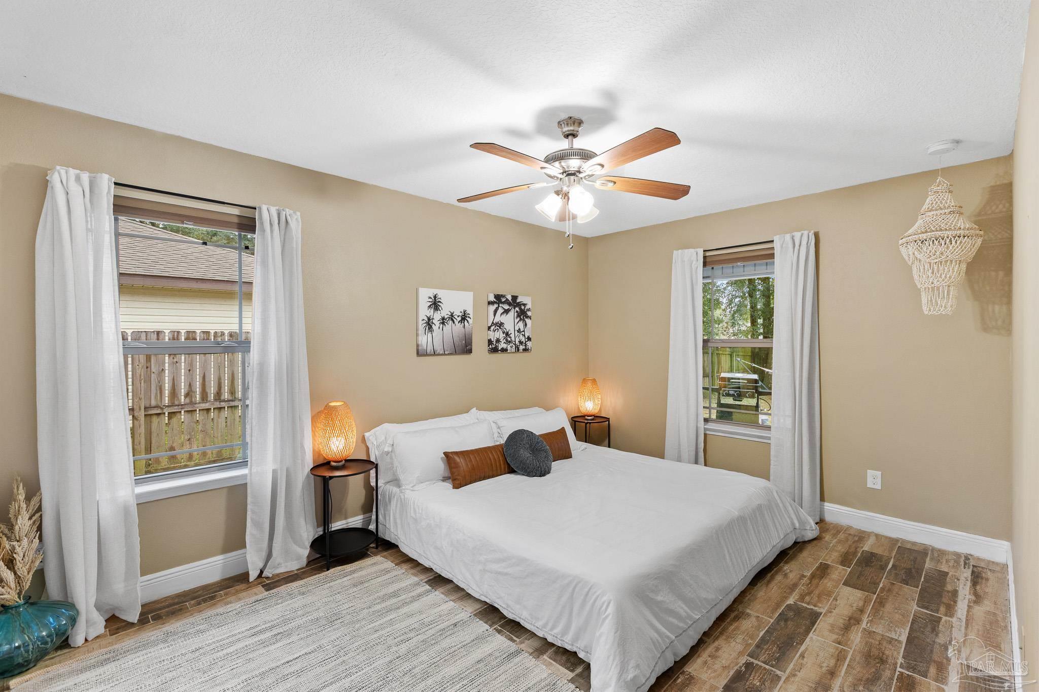 3963 Edgefield Street Pace, FL 32571 - Photo 15 of 30 a bedroom with a large bed and a window