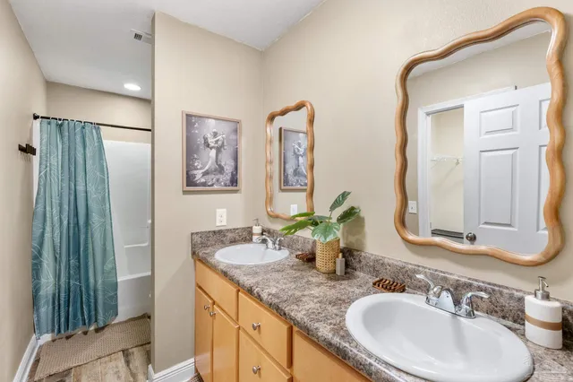 a bathroom with 2 sink and a mirror