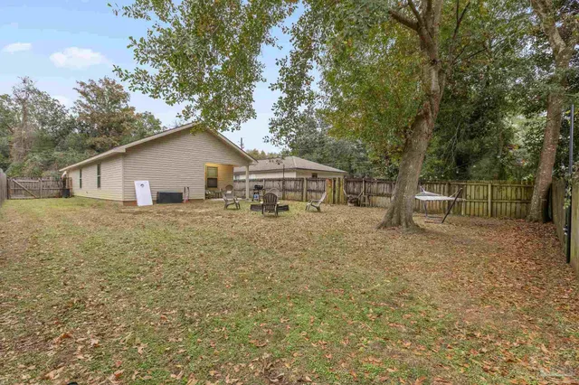 a white house that has a tree in front of it