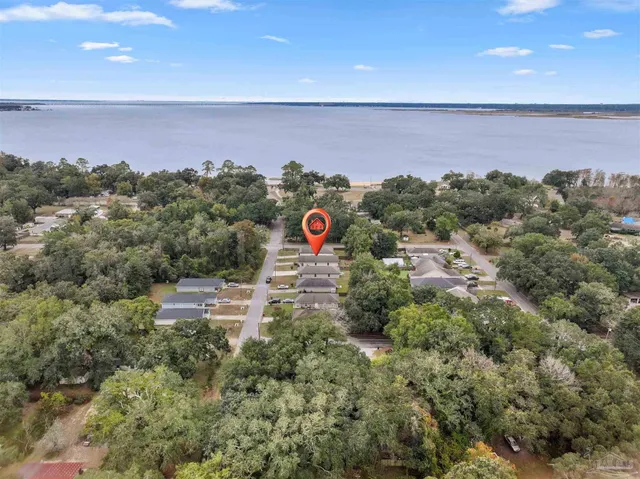 an aerial view of a houses with a yard