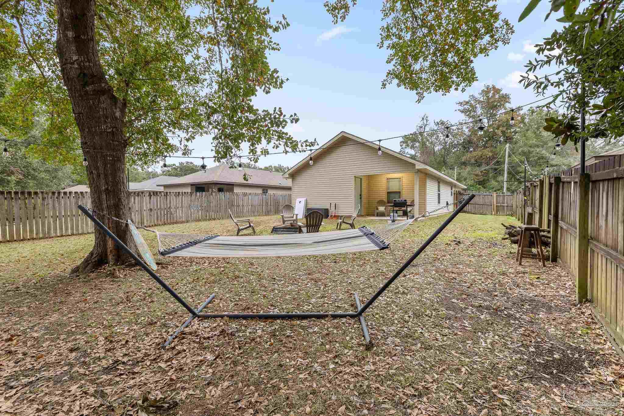 3963 Edgefield Street Pace, FL 32571 - Photo 29 of 30 a house with trees in the background
