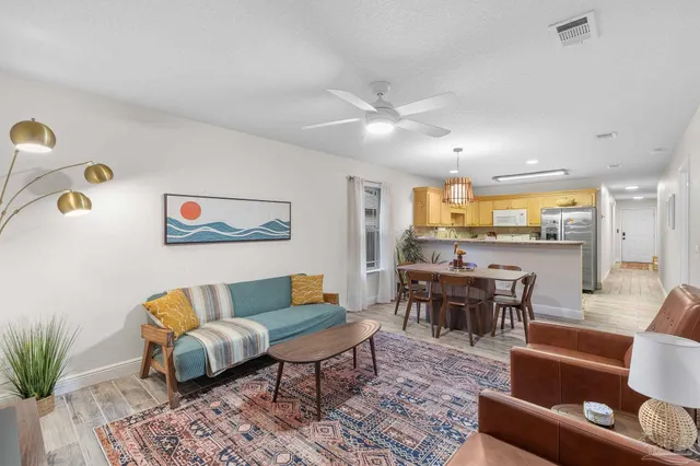 a living room with furniture and wooden floor