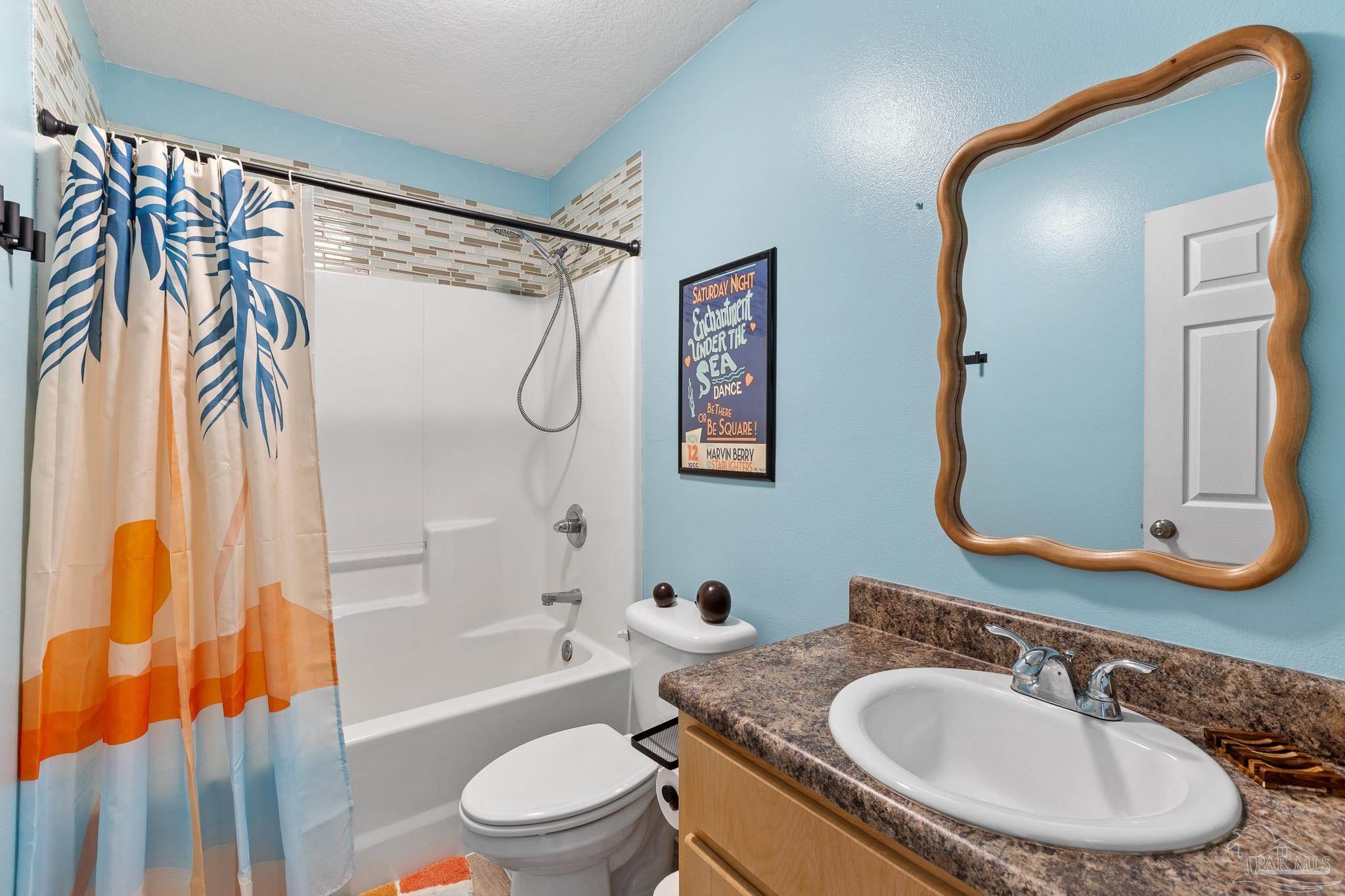 3963 Edgefield Street Pace, FL 32571 - Photo 9 of 30 a bathroom with a granite countertop sink toilet and shower