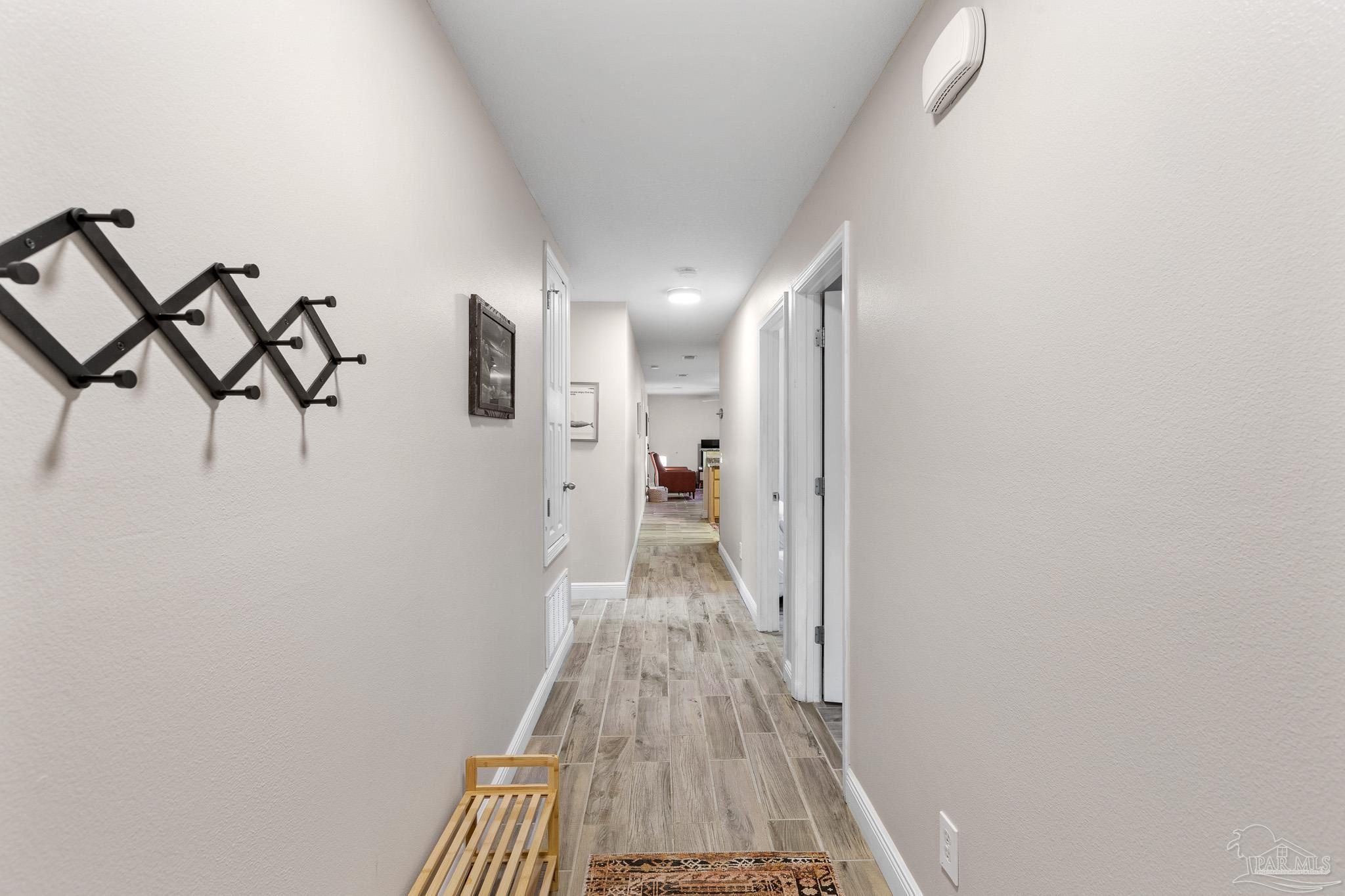 3963 Edgefield Street Pace, FL 32571 - Photo 10 of 30 a view of a hallway with wooden floor and staircase
