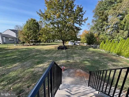 a view of a balcony with floor to ceiling windows and wooden fence