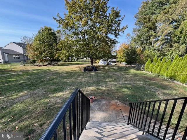 a view of a balcony with floor to ceiling windows and wooden fence