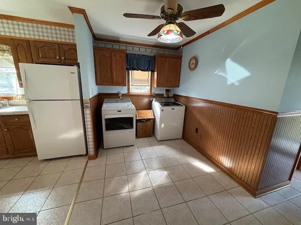 a kitchen with stainless steel appliances granite countertop a refrigerator a sink a stove top oven and cabinets