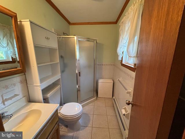 356 Lakeside Boulevard Hamilton, NJ 08610 - Photo 6 of 15 a white toilet sitting next to a bathroom sink and a shower