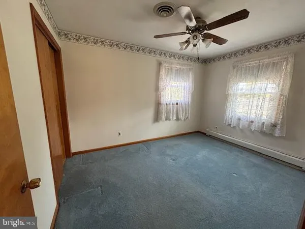 a view of a livingroom with a window and a ceiling fan