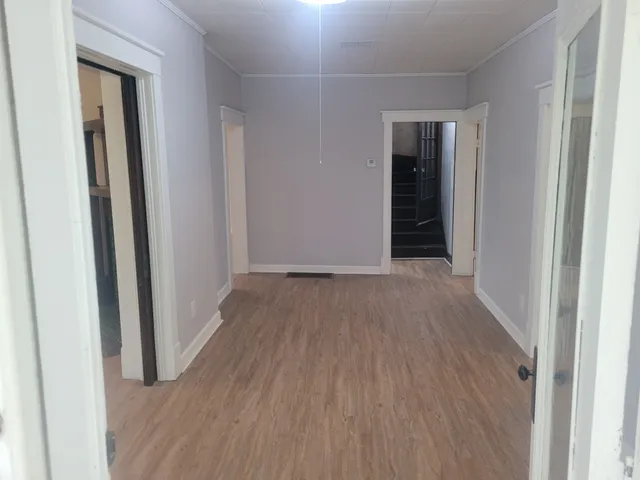 a view of a hallway with wooden floor