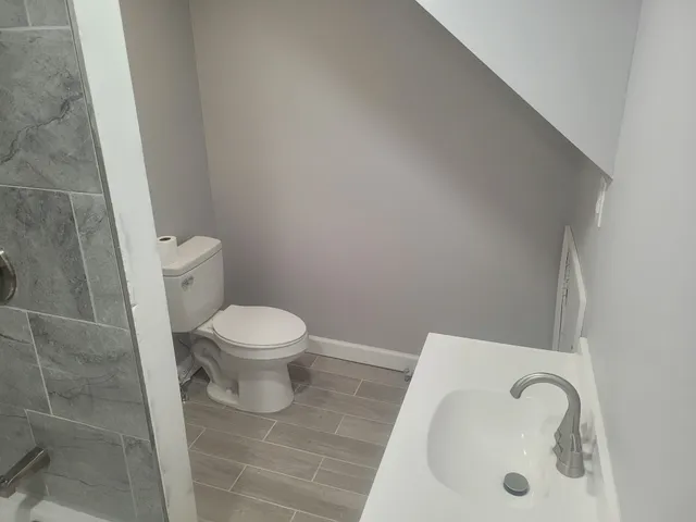 a bathroom with a toilet and a sink