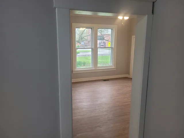 an empty room with windows and closet