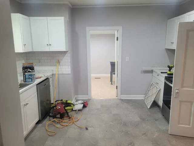 a room with furniture and white walls