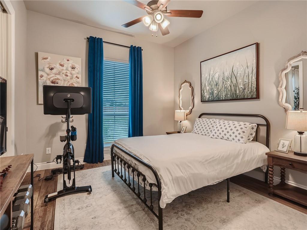132 Huerta Road Florence, TX 76527 - Photo 24 of 40 Hardwood floors and a ceiling fan create a comfortable and stylish retreat.