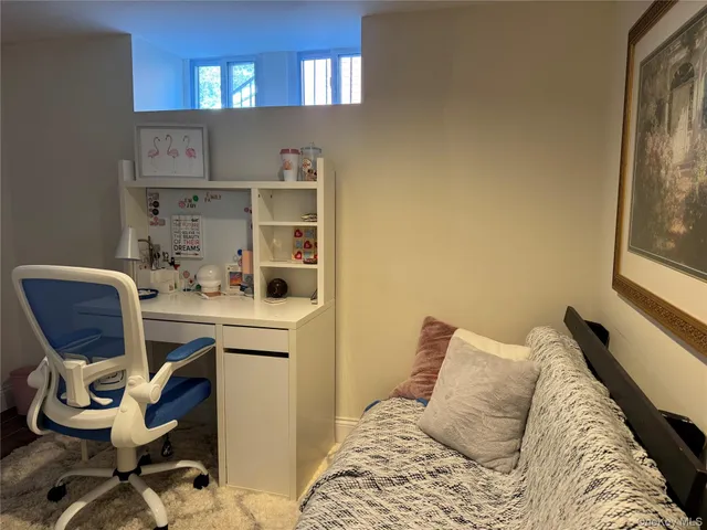 a bedroom with a bed and chair