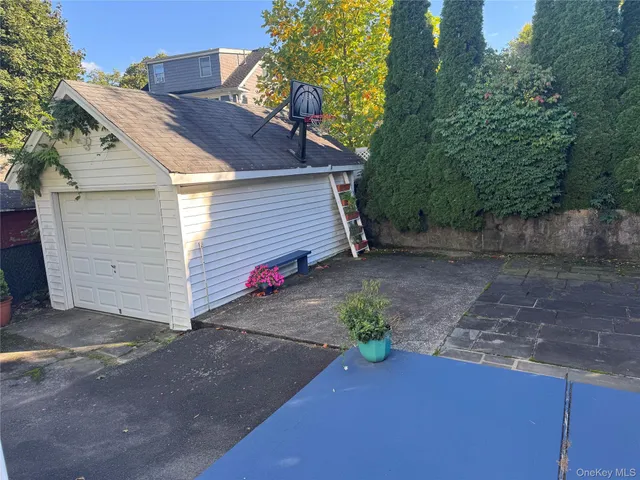 a view of a small house with wooden fence