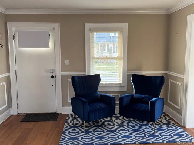 a living room with furniture rug and a window
