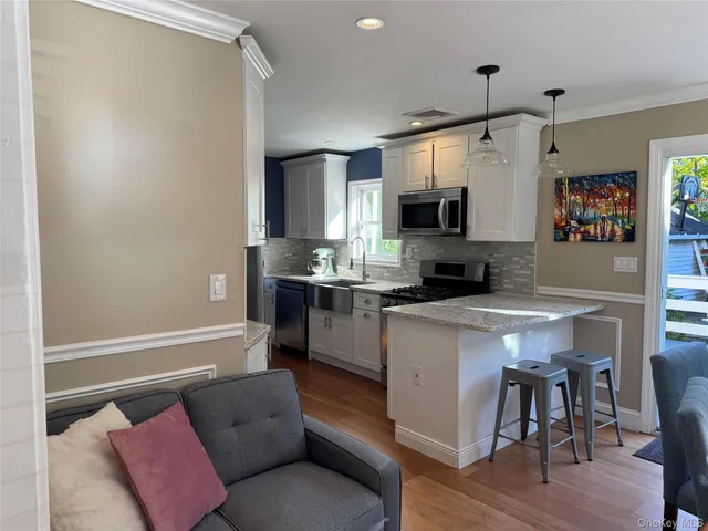 a kitchen with stainless steel appliances granite countertop a refrigerator a stove top oven a sink and dishwasher