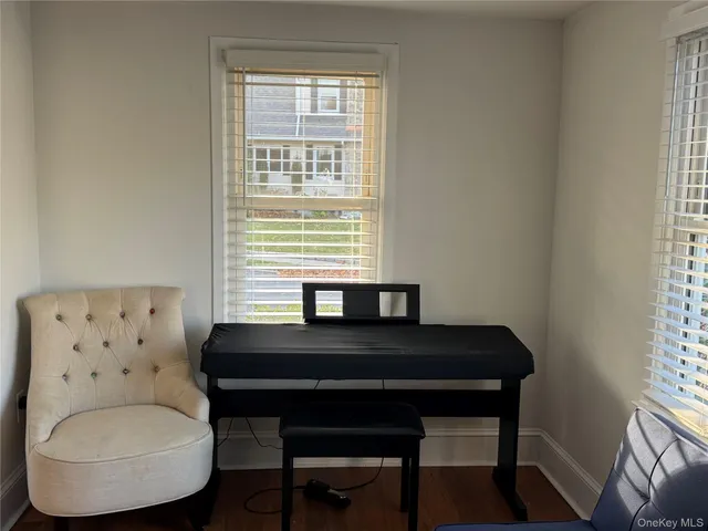 a view of a workspace with furniture and a window