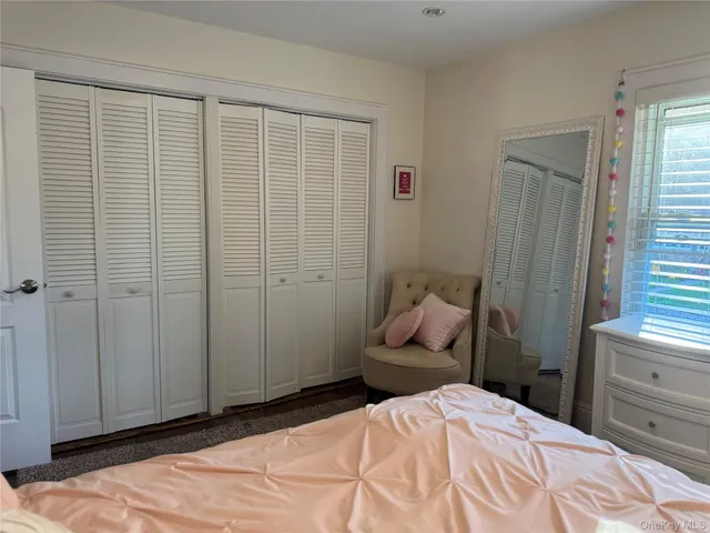 a bedroom with a bed and a chair